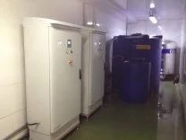 Two Envirolyte generator cabinets installed beside a blue storage tank