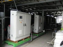 Two Envirolyte generator cabinets installed on green bases in an industrial processing area