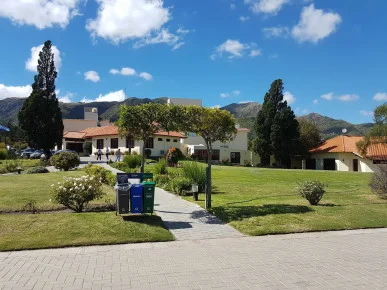 Landscaped hotel buildings and grounds at UTHGRA Los Cocos in Argentina
