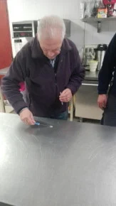 Technician applying or collecting a liquid sample on a stainless-steel surface