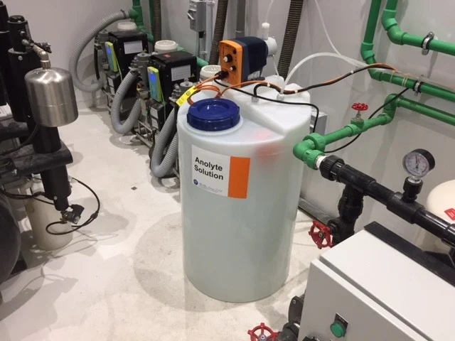 Anolyte storage tank and dosing equipment at a dental unit waterline disinfection installation