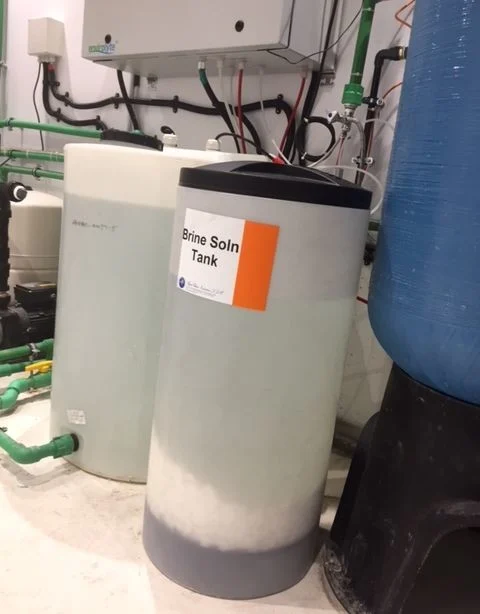 Brine solution tank connected to an Envirolyte dental water treatment generator