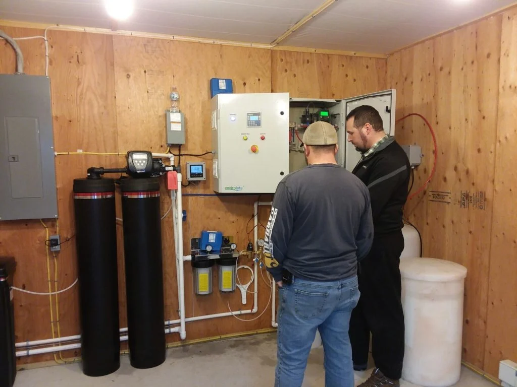 Envirolyte and Omnilyte technicians working on an anolyte generator installation at a poultry farm
