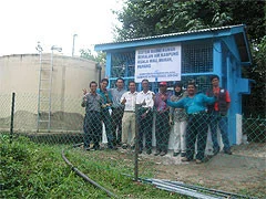 Water reservoir and adjacent pump house for rural drinking water treatment
