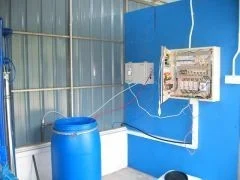 Electrical controls and solution tank inside the Kampong Jejok water-treatment building