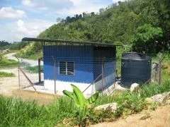 Blue treatment building and water storage tank at Kampong Jejok in Kelantan