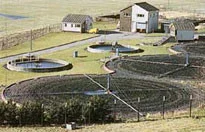 Outdoor water-treatment facility with circular basins, pipework and service buildings