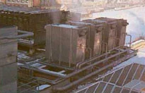 Industrial cooling equipment installed above a network of metal pipes
