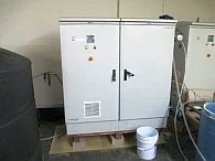 Envirolyte generator cabinet installed beside a solution storage tank