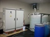 Envirolyte oil and gas generator cabinets with process tanks and auxiliary containers