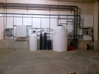 Envirolyte generator installation with solution tanks and water-treatment equipment at a dairy farm in Canada