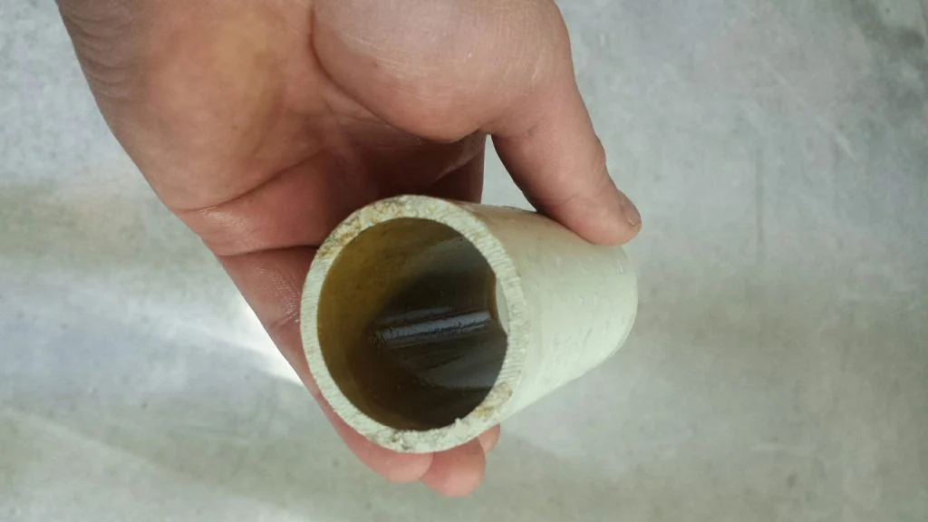 Interior of the same water pipe shown after anolyte dosing with reduced visible deposits