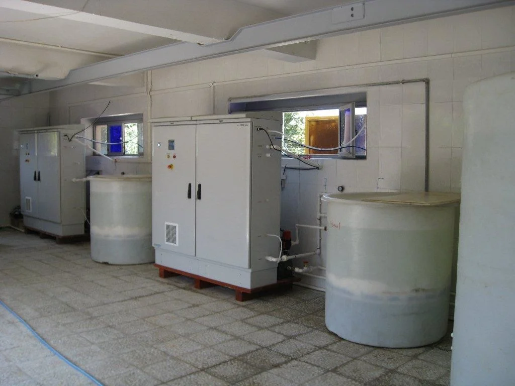 Envirolyte ELA anolyte generators with brine and solution storage tanks at a municipal water disinfection installation in Iran